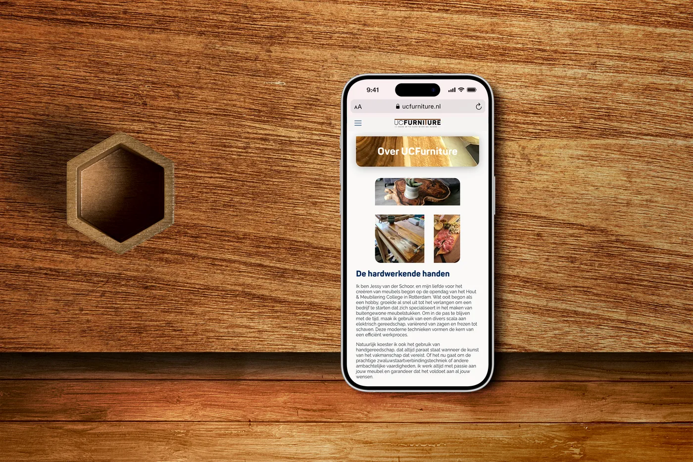 Smartphone met het ‘Over UCFurniture’ scherm, geplaatst op een houten oppervlak